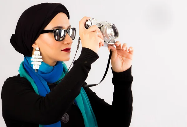 Young Woman holding old camera in hijab and colourful scarf — Stock Photo, Image
