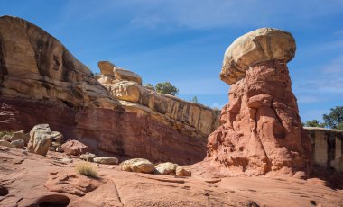 Golden sandstone geographical formations with a desert prairie landscape on a hot summer day at the Cohan Canyon Trail in Capitol Reef National Park Southern Utah. clipart