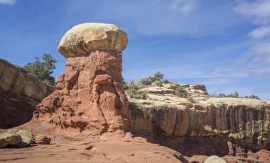 Golden sandstone geographical formations with a desert prairie landscape on a hot summer day at the Cohan Canyon Trail in Capitol Reef National Park Southern Utah. clipart