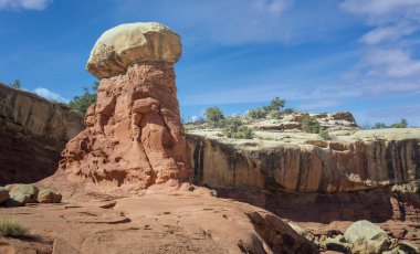 Golden sandstone geographical formations with a desert prairie landscape on a hot summer day at the Cohan Canyon Trail in Capitol Reef National Park Southern Utah. clipart