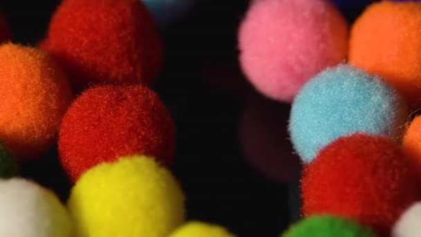 Fluffy and colorful little balls on black background — Stock Video