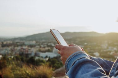 Kırsal kesimde cep telefonu kullanan genç bir bayan. Kırsal internet bağlantısı kavramı. 