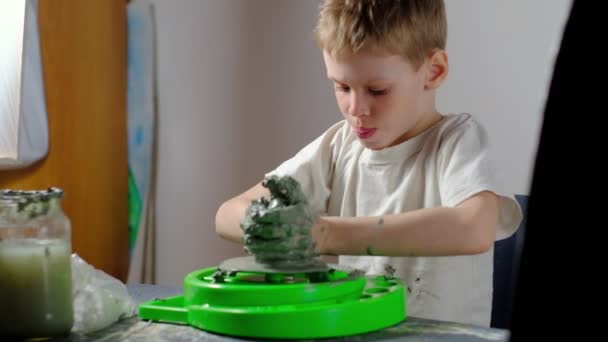 Seven Year Old Boy Soiled Clay Concentrating Making Clay Product — Stock Video