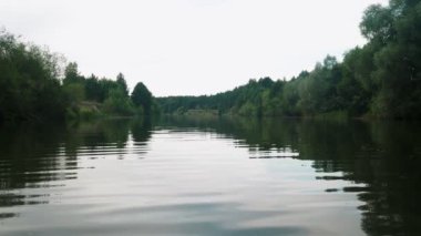 Yazın nehir. Sudaki ağaçların yansıması. Sudan gelen panorama. Yaz nehri manzarası.