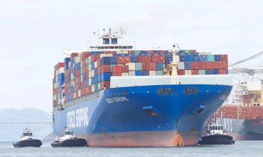 Oakland, CA - Apr 3, 2021: Multiple tugboats assist cargo ship COSCO EUROPE to maneuver into the Port of Oakland, the fifth busiest port in the United States.