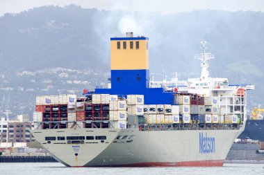 Oakland, CA - Apr 5, 2021: Matson Cargo Ship MANOA entering the Port of Oakland, the fifth busiest port in the United States. clipart