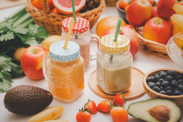 Freshly squeezed fruits with vegetables for making smoothies for breakfast together in the kitchen.diet and Health concept.