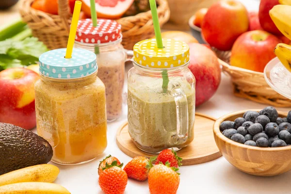 Freshly squeezed fruits with vegetables for making smoothies for breakfast together in the kitchen.diet and Health concept.