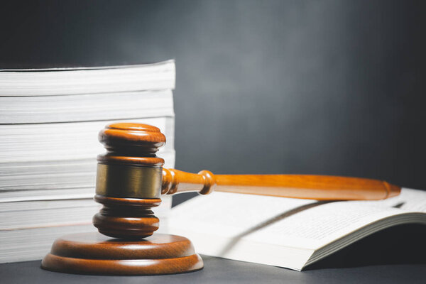 Old wood Judge hammer with law book on the table wood background, Used for adjudication and Justice.