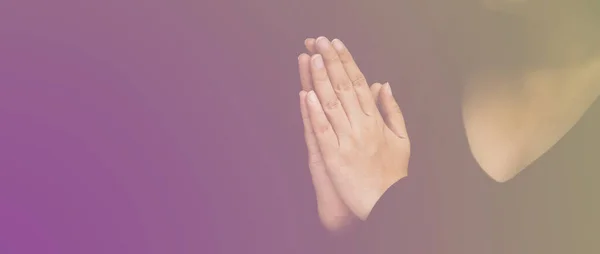 Woman\'s hand praying and worship to GOD Using hands to pray in religious beliefs and worship christian in the church or in general locations in vintage color tone or copy space.