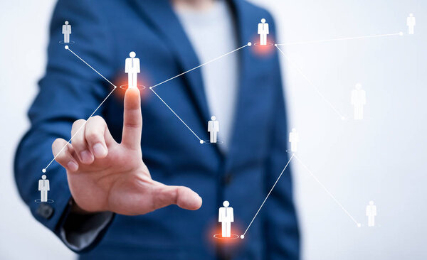 Businessman holding HR Human ,people icon on the graph Screen of a media screen, Technology Process System Business with Recruitment, Hiring, Team Building. Organisation structure concept.