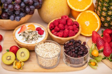 Grup meyveleri muz, portakal, çilek ve fındık karışımı, konsept sağlıklı gıda ve diyet, ahşap masanın en üst katında vejetaryen yiyecekler..