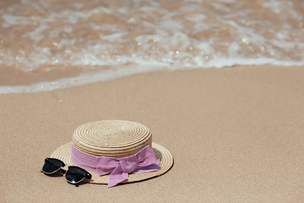Straw hat on a tropical beach