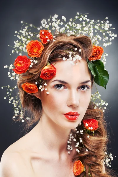 Fashion model with large hairstyle and flowers in her hair. Stock Picture