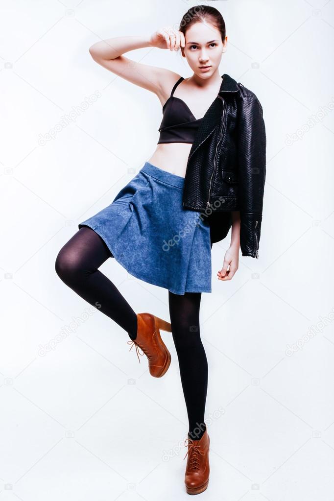 Casual dressed beautiful girl in full length posing over white background