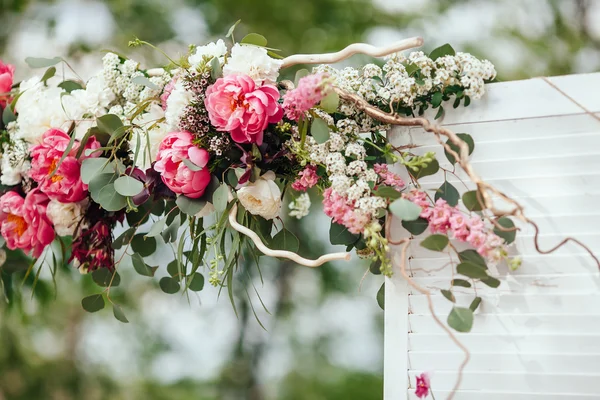 archway of many beautifil flowers, wedding arch with peones