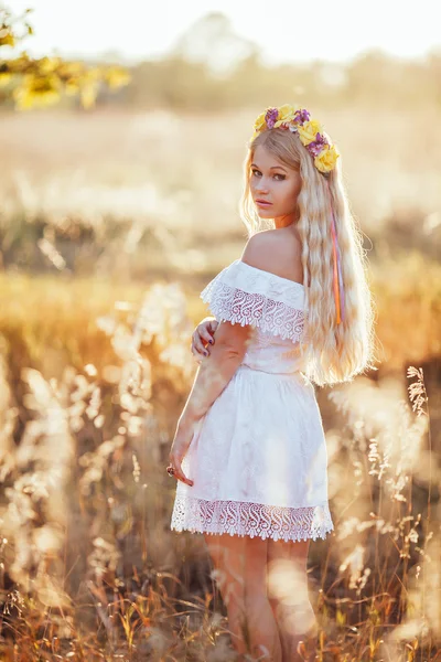 Çiçek çelenk ile beyaz elbise giyen sarışın kız portresi — Stok fotoğraf