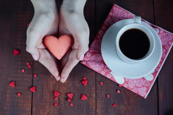 Abstract hands holding valentine macaroons and coffee — Stock Photo, Image