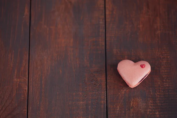 Srdce tvarovaný zákusek makarónek na dřevěný stůl. Valentine den koncept — Stock fotografie