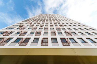 Aşağıdan yukarıya çok katlı bir binanın ön cephesi