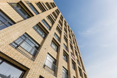 Aşağıdan yukarıya çok katlı bir binanın ön cephesi