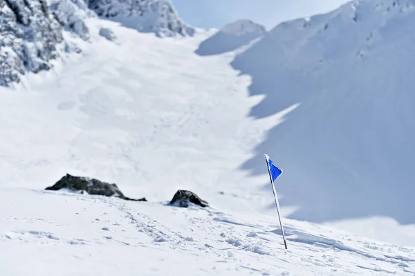 Drapeau bleu sur une montagne en hiver — Photo