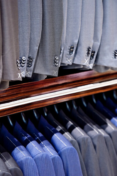 Elegant blue and gray suits in a store