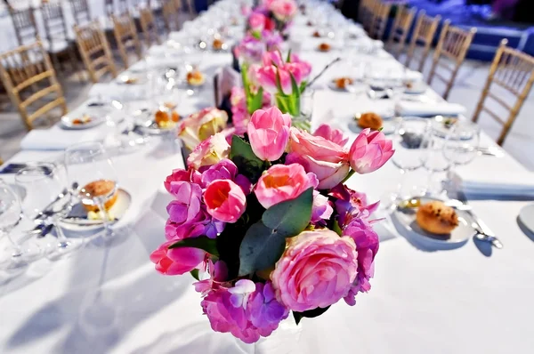 Festive dinner table with beautiful flowers bouquets — Stock Photo, Image