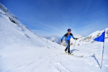 Ski mountaineer during competition in Fagaras Mountains clipart
