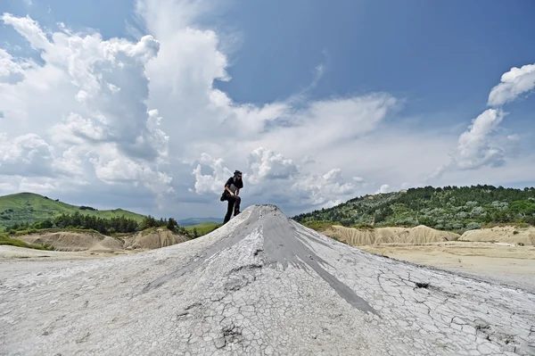 Mud volcanoes landcape with tourist — Stock Photo, Image