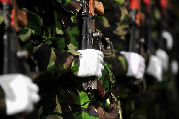 Soldier hand on AKM rifle — Stock Photo, Image