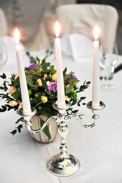 Candlestick on elegant dinner table — Stock Photo, Image