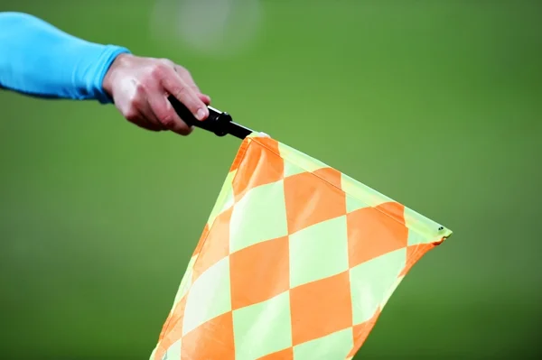 Assistant referee with flag up — Stock Photo, Image