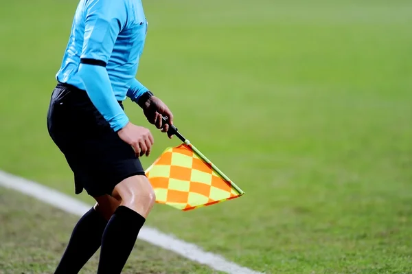 Assistant referee signaling with the flag — Stock Photo, Image
