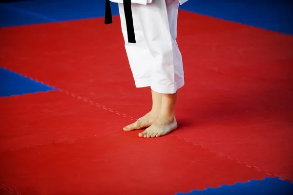 Karate practitioner on competition floor — Stock Photo, Image