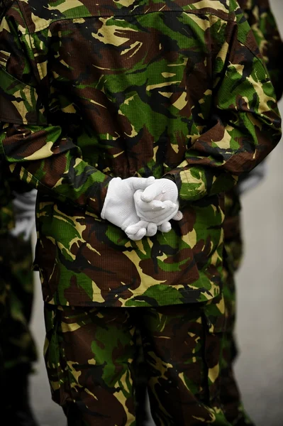 Soldier in camouflage uniform with hands behind his back — Stock Photo, Image