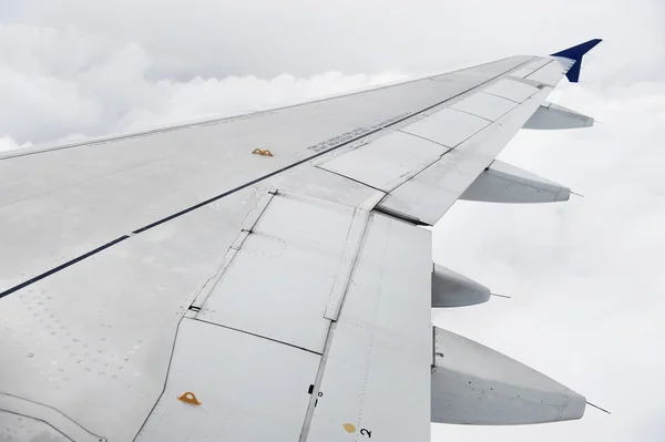 Airplane wing during stormy flight — Stock Photo, Image