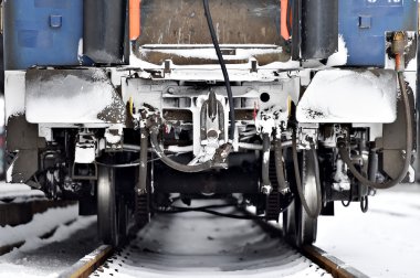 Train wagon buffers and links frozen in winter clipart