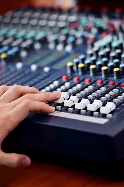 Hand adjusting audio mixer — Stock Photo, Image