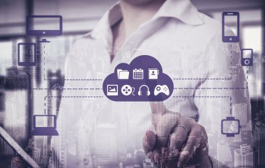 Businesswomen  touching a cloud connected to many objects on a virtual screen, concept about internet of things