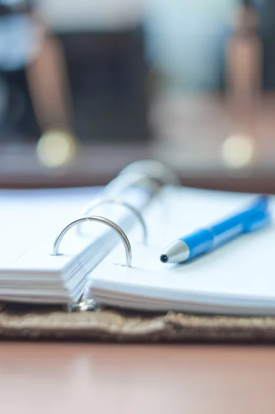 Личный органайзер и ручка на рабочем столе — стоковое фото