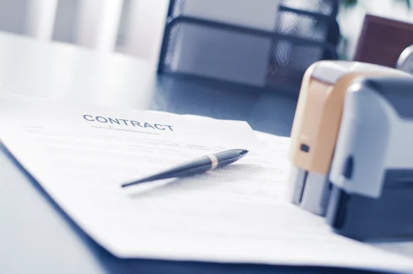 Contract on wooden desk with clock and fountain pen — Stock Photo, Image