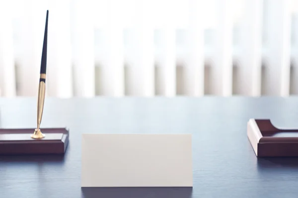 White triangular sign for the label standing on a black table. — Stock Photo, Image