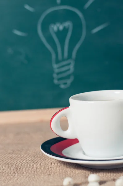 Coffee cup and business idea on wooden table — Stock Photo, Image