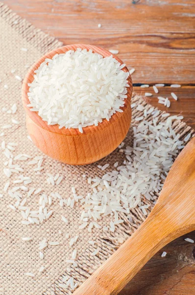Rice in a pot and spoon on burlap — Stock Photo, Image