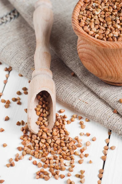 Buckwheat in a wooden bowl on white background — Stock Photo, Image