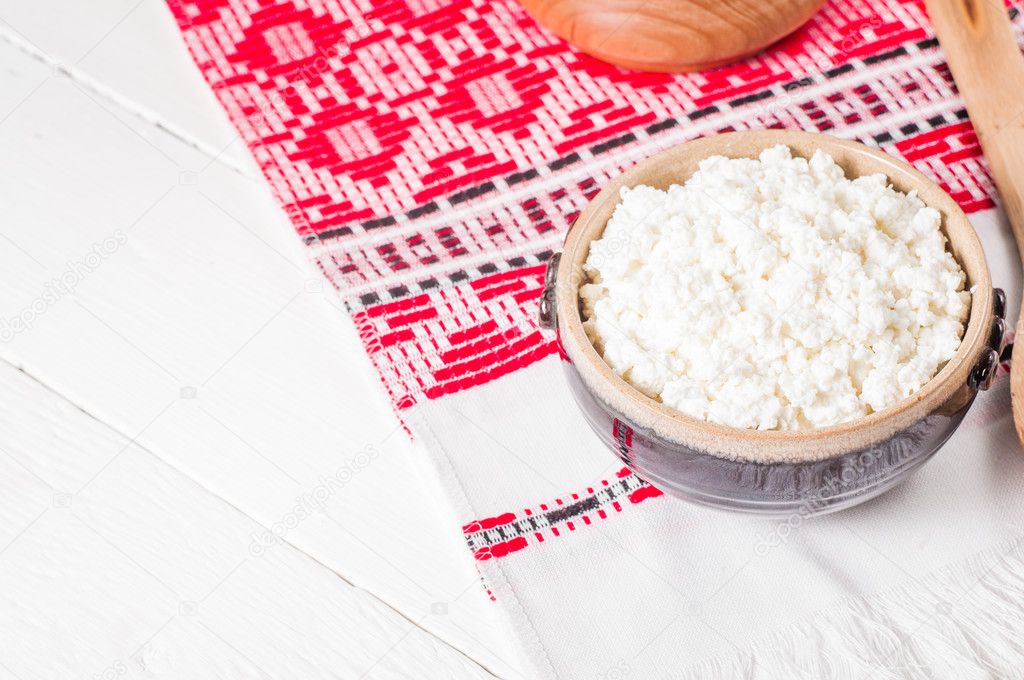 curd in brown bowl on the Ukrainian rushnyk