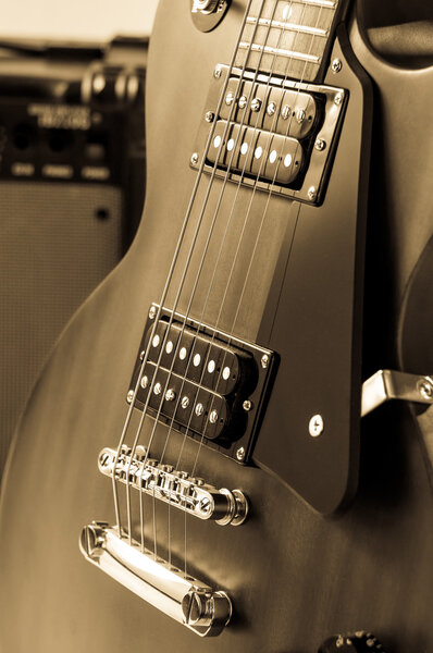 Detail of six-string electric guitar closeup, selective focus.Processed with vintage style.
