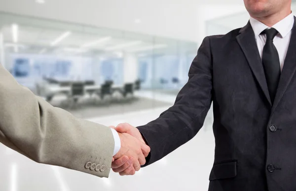 Handshake businessmen in the office background — Stock Photo, Image