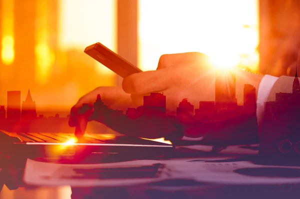 Man working from home using smart phone and notebook computer, using technology, flare light — Stock Photo, Image